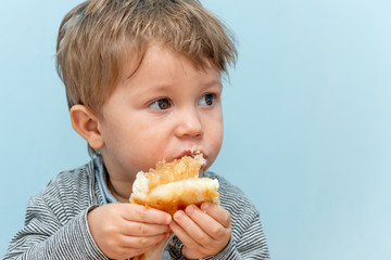 A one-year-old boy eats Traditional Serbian cheese pie gibanica alone