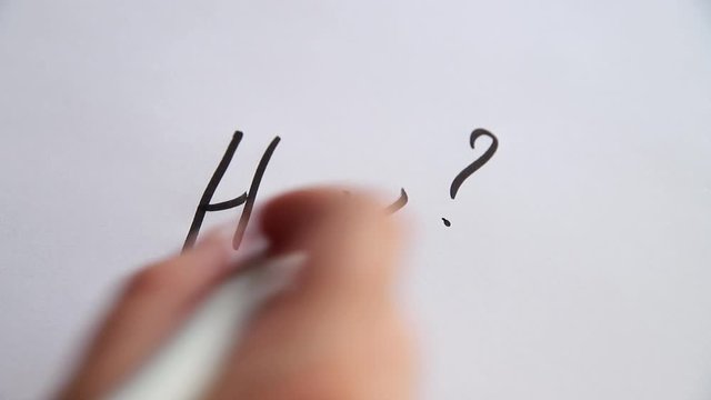 Hand writing How? on white paper