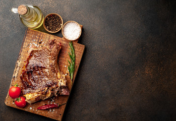 Grilled beef steak with spices on a stone background with copy space for your text.