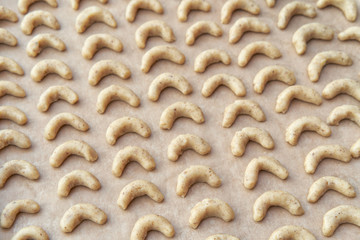 Top view of baking sheet with raw Christmas homemade cookies ready to bake.