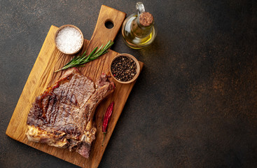 Grilled beef steak with spices on a stone background with copy space for your text.