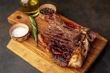 Grilled beef steak with spices. on stone background 