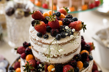 fruit wedding cake with different berrys above view