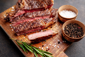 Grilled beef steak with spices. on stone background