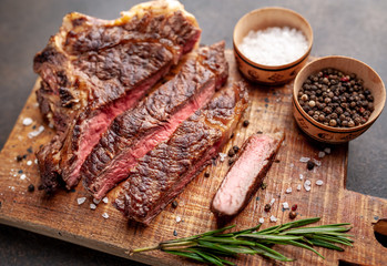 Grilled beef steak with spices. on stone background