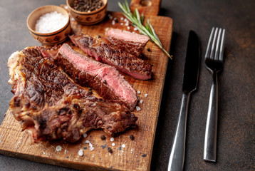Grilled beef steak with spices. on stone background