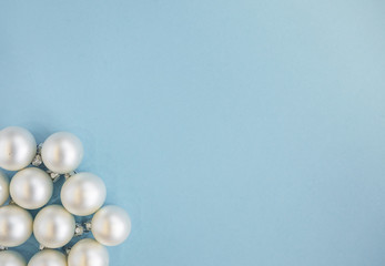 Christmas or new year flat lay with white balls on light blue background. Top view, copy space. 