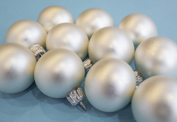 Christmas or new year flat lay with white balls on light blue background. Top view. 