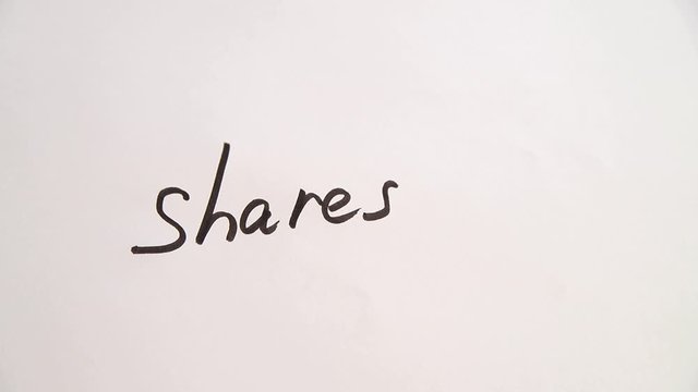 Hand writing Shares up on white paper