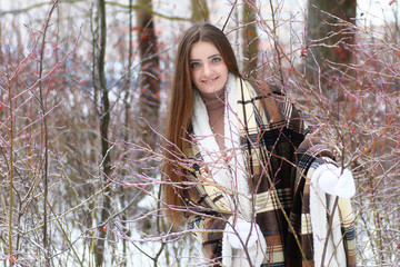 Young beautiful girl in winter snowy day