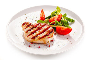 Grilled steak with vegetable salad on white background