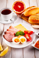 Continental breakfast on wooden table