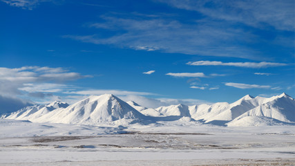 Snow covered Brooks Range mountains Alaska with blue sky from the Dalton Highway © Reimar