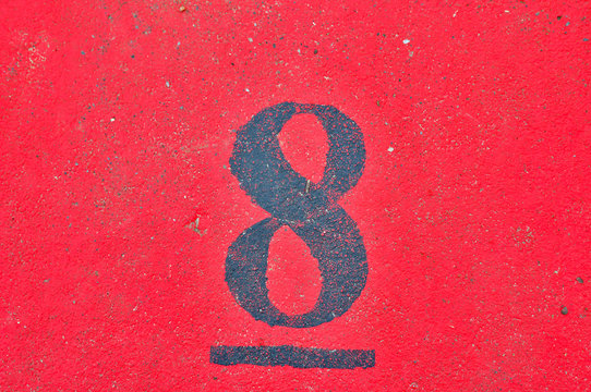 A house number plaque, showing the number eight (8)