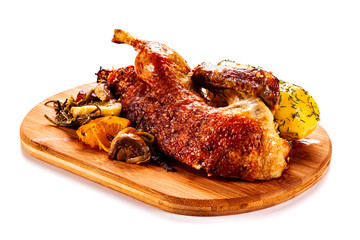 Roast duck on cutting board on white background