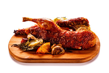 Roast duck on cutting board on white background