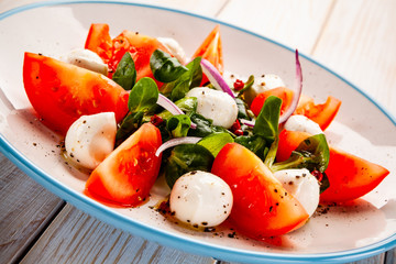 Caprese salad on wooden table