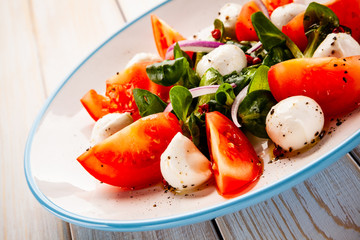 Caprese salad on wooden table