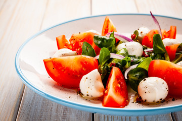 Caprese salad on wooden table