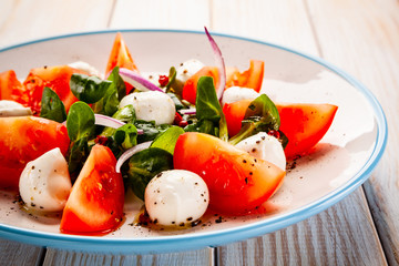 Caprese salad on wooden table