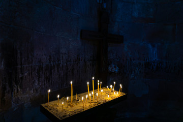 long lighted candles group on black background