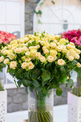 Fresh beige roses. Large, beautiful bouquet of beige roses. vertical photo