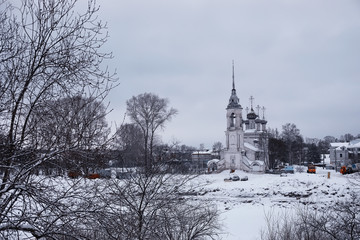 Winter forest landscape. Tall trees under snow cover. January frosty day in the park.