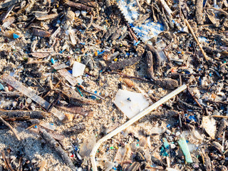 Environmental pollution. Sand beaches polluted with pieces of plastic waste. Micro plastics debris...