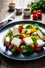  Fresh greek salad on wooden background