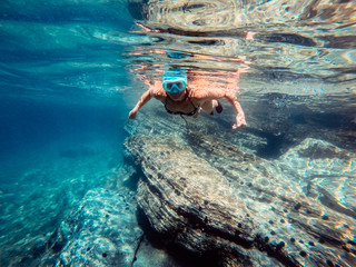 Woman snorkeling in the sea by the reef