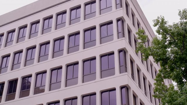 Modest, corner office exterior establishing shot.  4K, 10 bit lock-off.