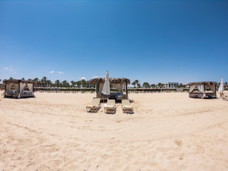 Marsa Matruh, Egypt. Elegant gazebo on the beach with sun beds. Relaxing context. Nobody on the beach. Fabulous holidays. Mediterranean sea