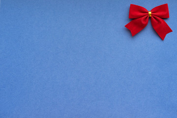 Christmas background with red velvet holiday bows border; blue copy space background