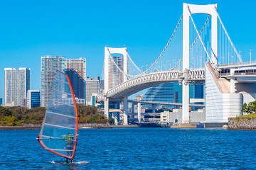 Japan.Tokyo. Rainbow bridge in Tokyo closeup. The Island Of Odaiba. White bridge in Tokyo on a summer day. Bridge on the background of high-rise buildings in Japan.