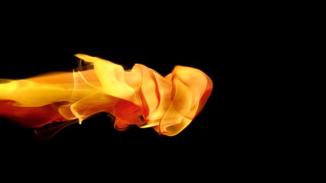 Yellow orange color paint ink drops in water slow motion art background with copy space. Inky cloud swirling flowing underwater. Abstract smoke fluid  liquid animation isolated on black alpha channel