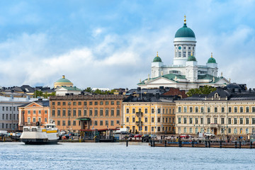 Fototapeta premium Helsinki. Finland. Panorama of Helsinki on a summer day. Suurkirkko. Cathedral Of St. Nicholas. Helsinki Cathedral. Gulf of Finland. Houses on the waterfront in the capital of Finland.