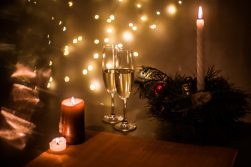 Christmas champagne on a table against the background of garlands