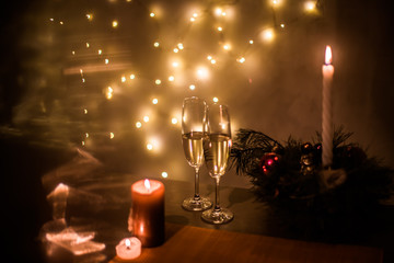 Christmas champagne on a table against the background of garlands
