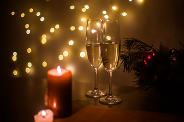 Christmas champagne on a table against the background of garlands
