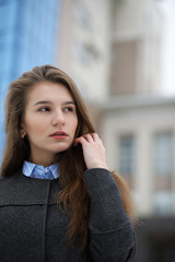 Fototapeta premium Young adult girl in coat on the street