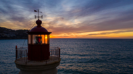 Fototapeta na wymiar lighthouse at sunset, in the port of Andratx, Majorca Spain