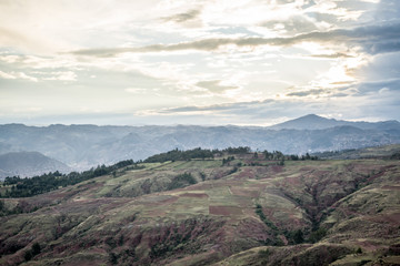  mountains near trees and cloudy sky