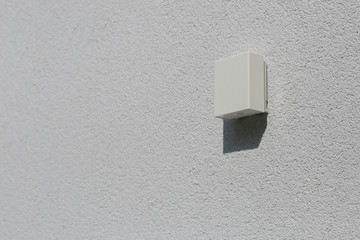 outdoor temperature sensor on white facade on house