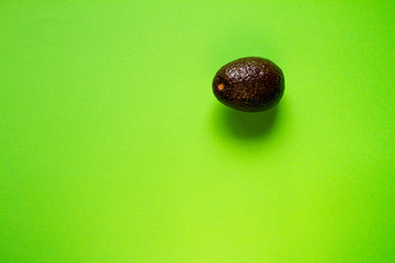 Row avocado on green background, creative food concept