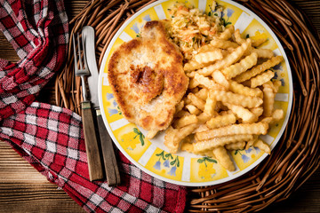 Pork chop, french fries and vegetables.