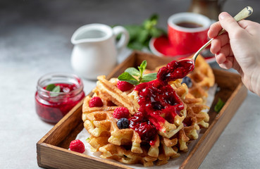 Homemade sourdough waffles with berry sauce for breakfast. The concept of proper nutrition....