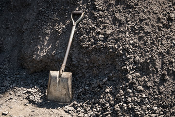 vintage shovel and pile of dirt or sand -