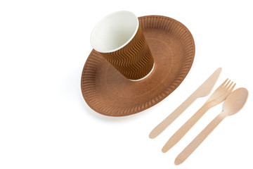 Eco - friendly plate with fork, spoon, knife and cup isolated on white background . Disposable tableware.