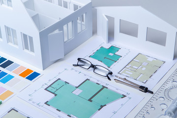 Architectural Bureau. Work in a construction company. Construction drawings. Drawings with a floor plan on an architect's desk. Comprehensive planning of construction. Workplace. Glasses. Palette