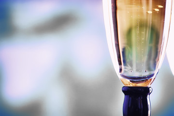 Background with tall glasses for sparkling wines. Champagne and spray in glass glasses. Celebratory drink with reflection.